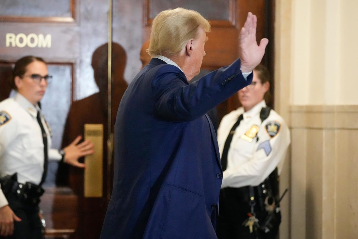 Former President Donald Trump motions as he returns to the courtroom after a break in his civil business fraud trial at New York Supreme Court, Wednesday, Oct. 25, 2023, in New York. The judge in Donald Trump's civil fraud trial has fined the former president $10,000. The judge says Trump violated a limited gag order barring personal attacks on court staffers.