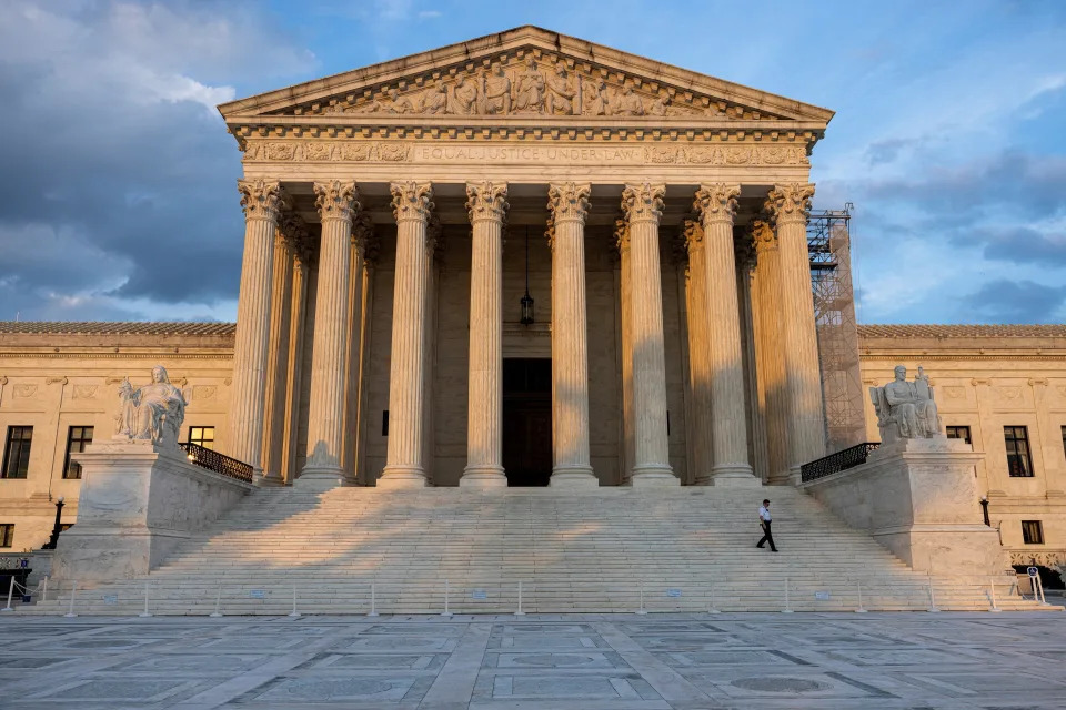 A security guard walks down the steps of the U.S. Supreme Court building in D.C.