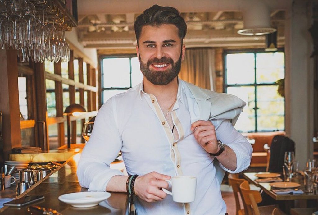 Ali Ayad smiling in a restaurant