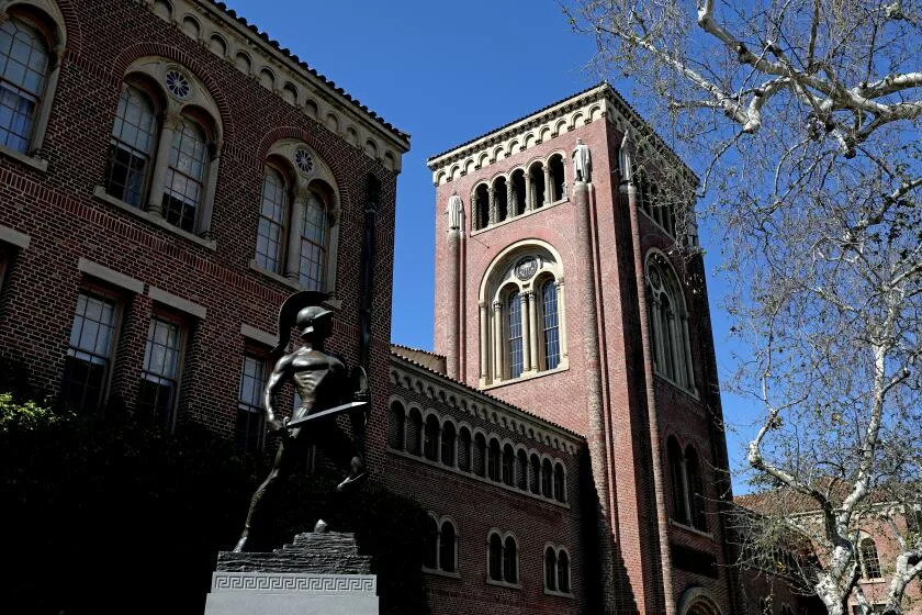 Bovard Administration Building with Tommy Trojan sculpture on the Campus of the University of Southern California. Bovard Administration Building with Tommy Trojan sculpture on the Campus of the University of Southern California.
